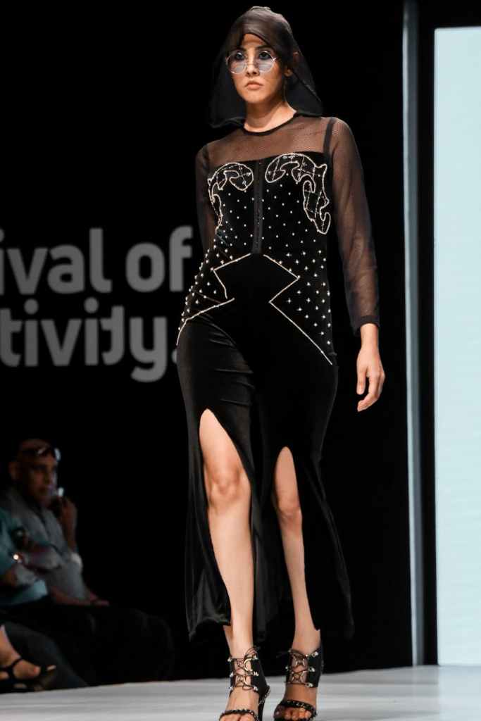 photo of runway model modelling a black outfit