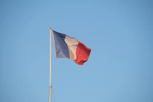 close up of the french flag against a clear blue sky